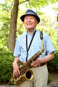 サックスを手に「人との出会いを豊かにしてくれた。ジャズは最高の音楽」と語る日下雄介さん（撮影・中西幸大）