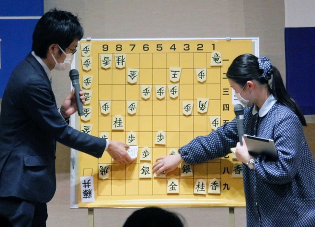 王将戦第２局の戦況を大盤解説会で語る稲葉陽八段（左）と藤井奈々女流初段＝２２日午後、大阪府高槻市