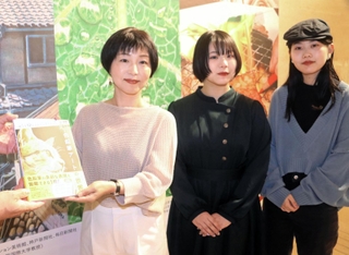 １万人目の来場者となり記念品を受けとった（左から）由水由佳さんと娘の美帆さん、杏実さん＝神戸市東灘区向洋町中２、神戸ファッション美術館