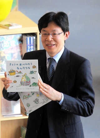 読み聞かせた経験がある絵本を手に講演する谷川浩司十七世名人＝１月２７日、神戸市中央区「こども本の森　神戸」
