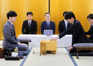 加古川青流戦の開幕局で初手を指す上野裕寿四段（右）。左は宮嶋健太四段＝１８日午前、加古川市加古川町溝之口