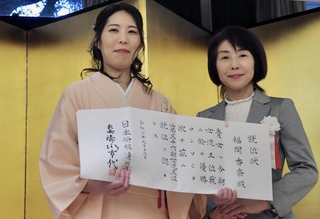 日本将棋連盟の清水市代会長（右）から就位状を受け取った福間香奈女流王位＝１６日午後、東京都千代田区