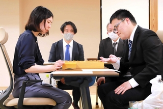 棋士編入試験の第３局の終局後、感想戦に臨む福間香奈女流五冠（手前左）と生垣寛人四段＝３月２７日午後、大阪府高槻市、関西将棋会館