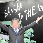 「播州から世界へ」のスローガンを前に、次の１００年を語る田井三治社長＝兵庫県多可町中区高岸、多可Ｒ＆Ｄセンター