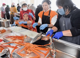 漁師らからアドバイスを受けながら調理する参加者ら＝明石市中崎１、兵庫県水産会館