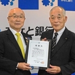 みなと銀行育英会の服部博明理事長（左）に感謝状を手渡す武庫川女子大の瀬口和義学長＝みなと銀行本店