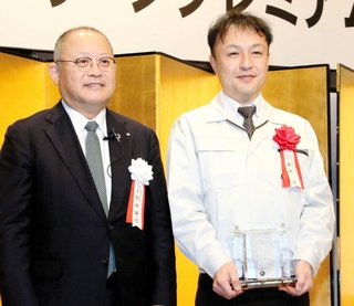 「あましんグリーンプレミアム」で最優秀賞に輝き、記念撮影に収まる丸美化成の森地崇常務（右）と尼崎信用金庫の作田誠司理事長＝尼崎市昭和通２