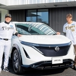 阪神タイガースの新２軍施設で導入する電気自動車と並ぶ平田勝男２軍監督（左）、糸井嘉男氏（阪神電気鉄道提供）