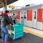 電車車両に農産物を積み込む「神鉄食彩館　新開地店」の従業員ら＝神戸市北区藤原台中町１、神戸電鉄岡場駅（神戸市提供）