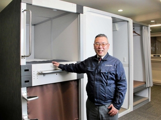 本社のショールームでカプセルベッドを紹介するコスモンドの竹田正邦社長＝神戸市中央区港島中町５