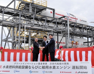 液化水素タンク前で記念撮影に応じる川崎重工業とジャパンエンジンコーポレーション、ヤンマーパワーソリューションの代表者＝明石市二見町南二見