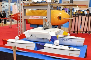 日本海工の水上ドローン（手前）や川崎重工業のＡＵＶ（奥の黄色い製品）などが展示された「テクノオーシャン」会場＝神戸市中央区港島中町６