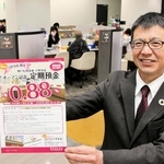 昨年11月にオープンした神戸信用金庫の六甲支店で、優遇金利の定期預金のチラシを持つ井筒篤史次長＝神戸市灘区桜口町４