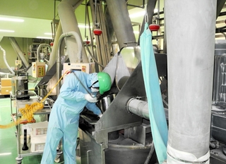 調合した原料を確認する従業員。粉体技術が生産の要だ＝静岡県藤枝市、アース製薬藤枝工場