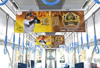 阪神タイガースのリーグ連覇を祝って選手らのポスターで飾られた車両内＝７日午後、尼崎市北城内、阪神電鉄尼崎車庫（撮影・斎藤雅志）