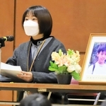 阪神・淡路大震災で亡くなった同級生の中島祥子さんを思いながら、遺影の隣で講演した松村彩子さん＝２０２２年１月１７日午前、芦屋市新浜町、芦屋市立打出浜小学校