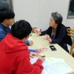 沖縄にルーツを持つ尼崎市在住者に聞き取り調査をする学生＝２０１９年、尼崎市（桃原教授提供）