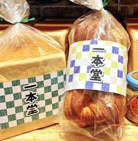 格子柄の色紙が巻かれたオリジナルの「潮江食パン」（提供）