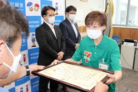 署長感謝状を受け取った豊増里三さん（右）＝尼崎東署