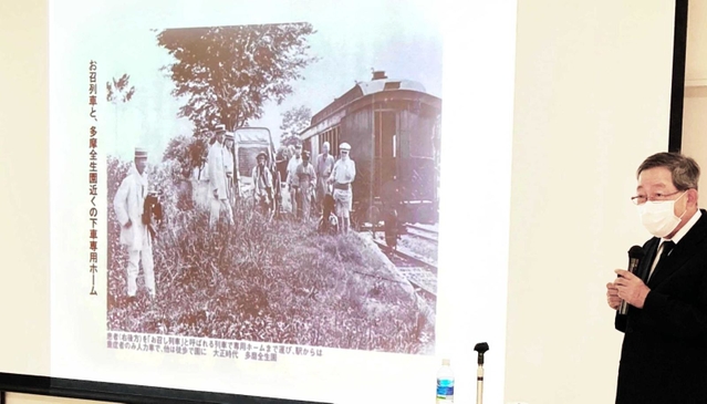ハンセン病患者を療養所まで送る通称「お召列車」などの写真を示して隔離政策の問題を語る畑野研太郎・邑久光明園名誉園長＝園田東生涯学習プラザ