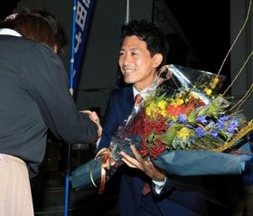 再選を確実にし、支援者から花束を受け取る越田謙治郞氏＝川西市小戸１（撮影・斎藤雅志）