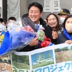 庁舎前で市民から花束を贈られて笑顔の松本真・尼崎市長（中央）＝尼崎市役所（撮影・斎藤雅志）