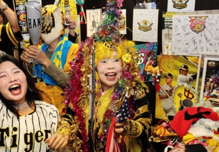 阪神が日本一を決めた夜、店で常連客らと熱い声援を送った引田孝子さん（中央）＝２０２３年１１月５日＝尼崎市西難波町６、尼のトラのおばちゃんの店