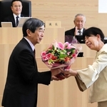 議員から花束を受け取る藤原保幸市長（左）＝伊丹市議会議場