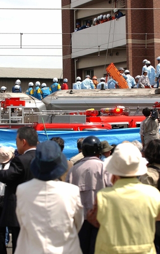 心配そうに救出現場を見守る市民ら＝２００５年４月２５日、尼崎市