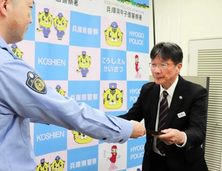 署長感謝状を受け取る阪神タクシーの高橋暁さん（右）＝西宮市甲子園七番町