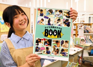 「子ども司書おすすめＢＯＯＫ」を持つ中桐亜虹さん＝芦屋市立図書館本館