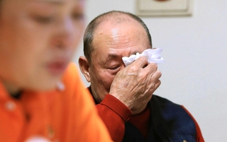 中国で亡くなった母の記憶をたどり、目頭を押さえる趙維清さん（右）。娘の萍さん（左）が三和之家での暮らしを支える＝尼崎市内（撮影・小林良多）