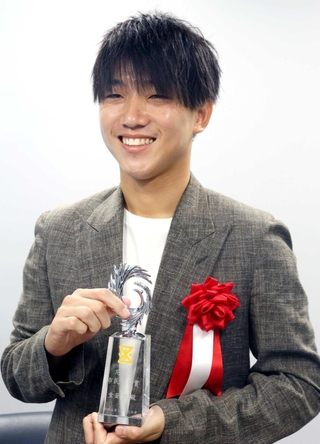 市民栄誉賞の記念トロフィーを代理で受け取った堂安憂さん＝尼崎市杭瀬南新町３