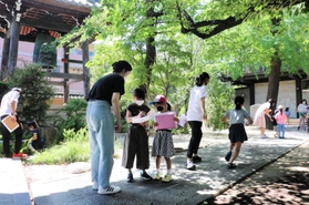 勉強後に境内で謎解きゲームをして遊ぶ子どもと高校生たち＝７月下旬、神戸市東灘区御影本町６