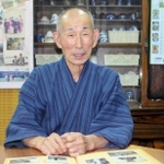 アルバムを眺めながら、幼い少年が感じた戦争を振り返る黒田さん＝姫路市