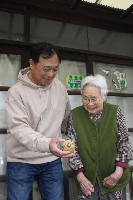 藤田監督のサインボールを見つめ、当時の思い出を語る井上和彦さん（左）と、母みさ子さん＝姫路市書写