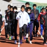 田中希実選手（中央）のウオーミングアップを間近で見ながら体を動かす中高生ら＝姫路市中地