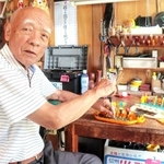 自宅ガレージでおもちゃの修理を続ける吉田清彦さん＝姫路市東今宿