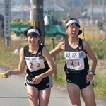女子・姫路西の１区渡辺晴香選手（右）からたすきを受け取る２区肥塚暖歌選手＝丹波篠山市内（撮影・風斗雅博）