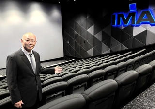 「アイマックスシアター」の魅力をＰＲする吉岡一博社長＝アースシネマズ姫路