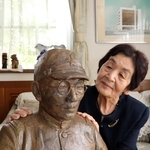 父、福井博さんの胸像を見つめる田中洋子さん＝姫路市広畑区