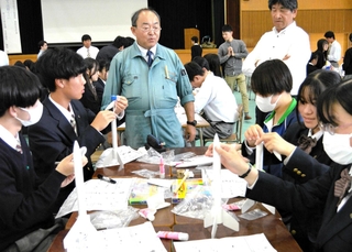 紙製ロケットの作り方を手ほどきする植松努さん（中央）＝姫路市網干区新在家、網干高校