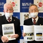 加西市老人クラブ連合会が作成した冊子を持つ山下光昭会長（左）と吉田廣顧問＝同市役所