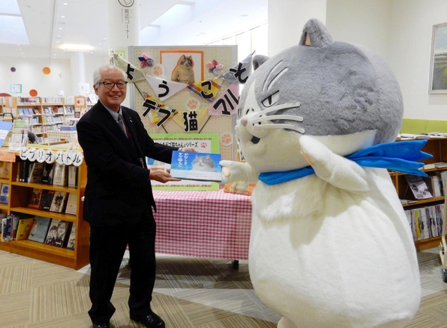 西脇市図書館を訪問し、笹倉邦好教育長（左）に絵本をプレゼントするマル＝西脇市野村町茜が丘