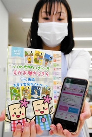 西脇市が製作した子育て支援のガイドブックとアプリ画面＝同市役所