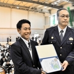 全校生約４３０人の前でのじぎく賞を受けた西田悠生さん（左）と大戸英治署長＝小野工業高校