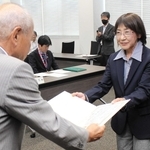 西脇市議選の当選証書を受け取る長谷川智春氏（右）＝西脇市役所