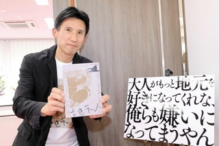 日本地域コンテンツ大賞を受賞した「地元人」創刊号と高橋武男さん＝３月、加東市上三草