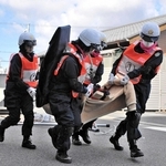 災害救助訓練で要救助者を運ぶ女性警察官＝小野署