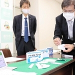 実証事業で使用する検査キットを紹介する塩野義製薬の社員＝養父市役所